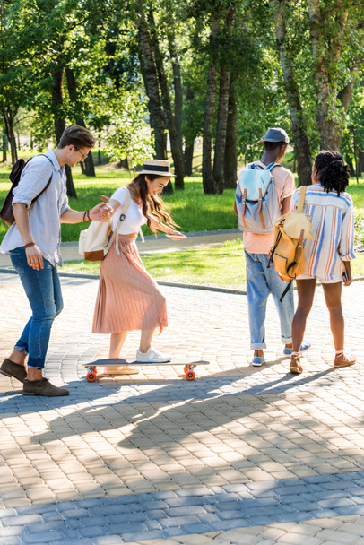 multiethnic friends walking in park - Foto, immagini