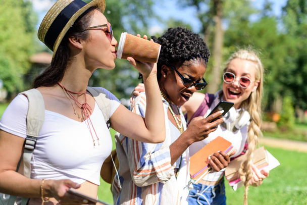 multiethnic girls using smartphone - 写真・画像