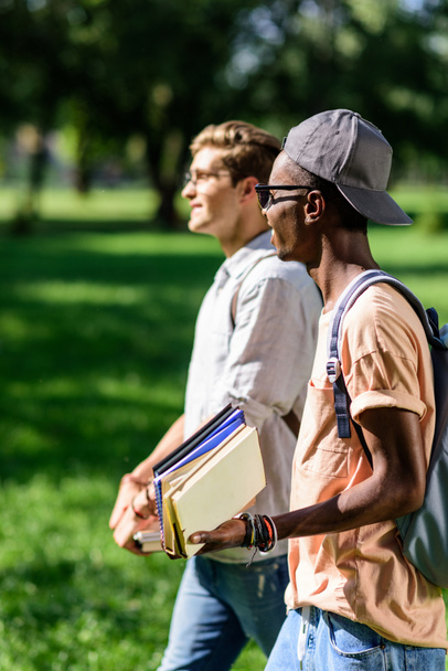 multiethnic students with books in park - Фото, зображення