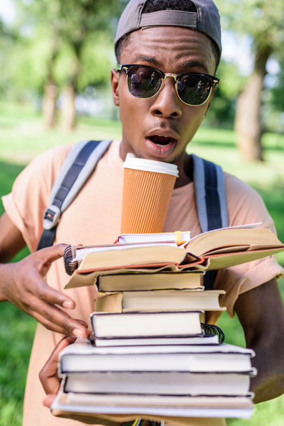 young man with pile of books - Photo, Image