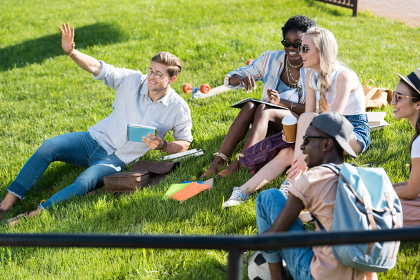multiethnic students resting in park - Photo, image