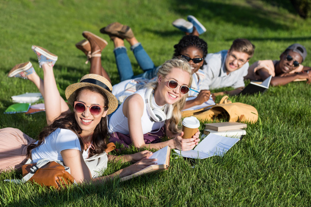 multiethnic students reading books in park - Photo, Image