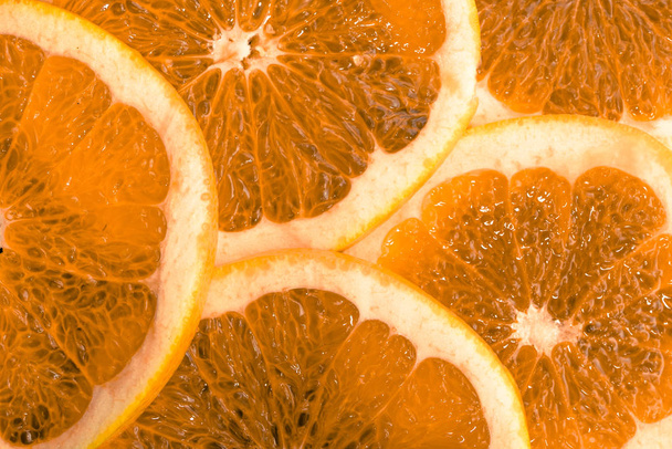 Texture of orange fruit slices, closeup, overhead, citrus background - Foto, Bild