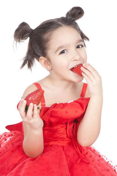 Little girl with strawberry on white background - Photo, Image