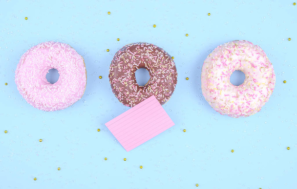 Colorful donuts on blue background. - 写真・画像
