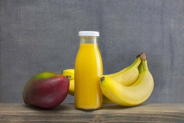 organic smoothie mango and bananas juice glass on wood .Tropical fruit concept.. - Photo, Image