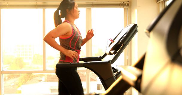 Woman exercising on a treadmill - Photo, Image