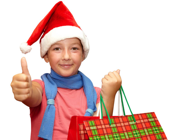 Little girl in red cap with shopping bags. Christmas - Фото, зображення