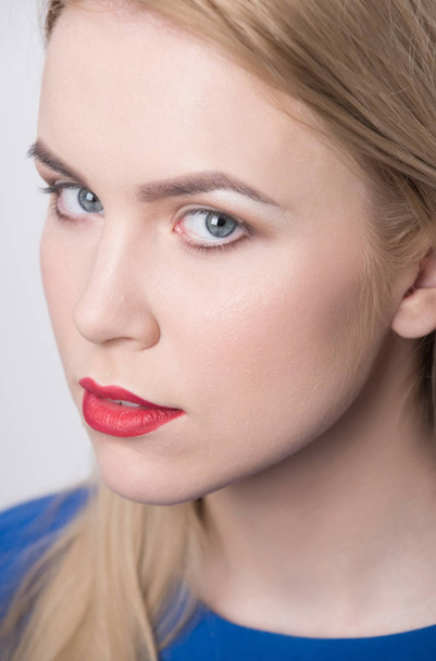 Girl with red lips and professional makeup on adorable face - Φωτογραφία, εικόνα