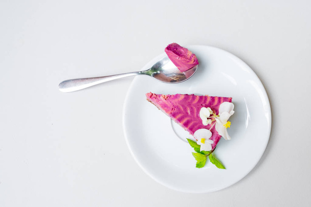 piece of cheesecake with blueberries on a white plate on a white background. . view from above. - 写真・画像
