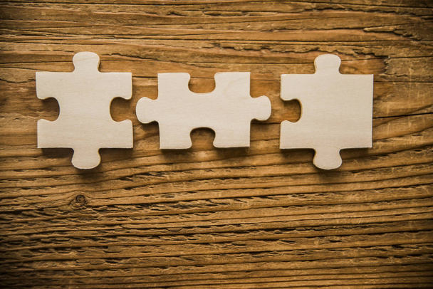  pieces of puzzle  on wooden table - Photo, Image