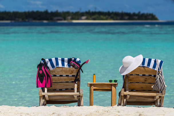 Picture of wooden beach chairs on the tropical beach, vacation.  - Photo, Image