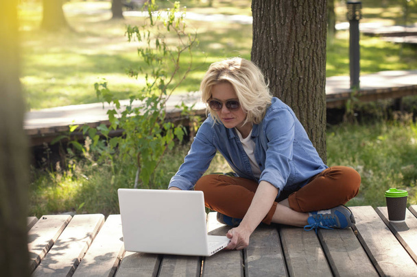 happy beautiful woman, girl with laptop surfing the web nearby lake - Foto, immagini