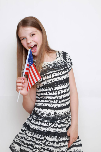 little girl holding USA flag in studio - Fotoğraf, Görsel