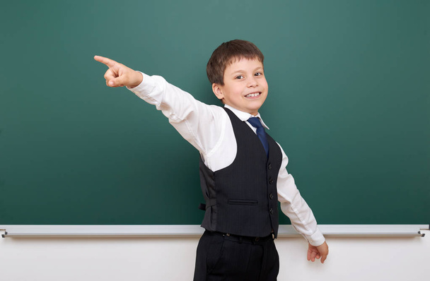 Schoolboy posing at school board, empty space, education concept - Foto, immagini