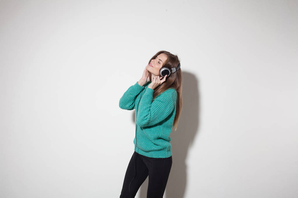 beautiful girl listens to music in headphones - Fotó, kép
