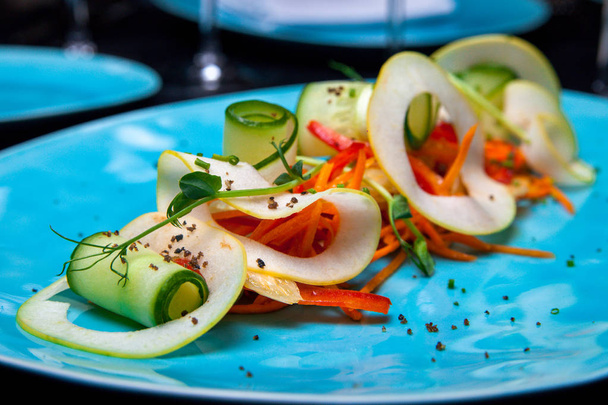 Frühlings-Fitness-Salat mit Apfel, Karotte, Gurke und Paprika im Restaurant vom Koch - Foto, Bild