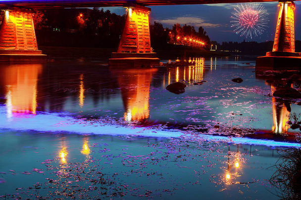 Firework over bridge night city reflected in water Uzhorod - Photo, Image