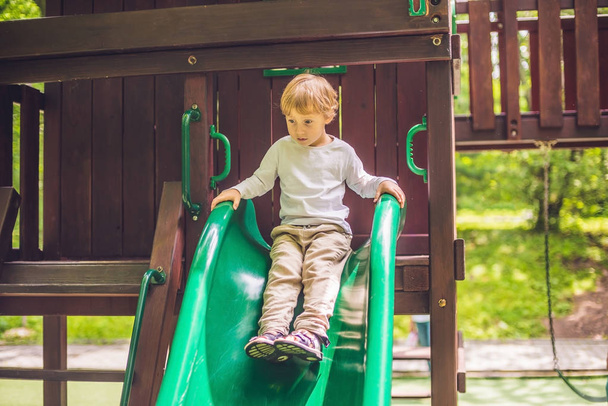 boy is playing on  wooden playground - Fotoğraf, Görsel