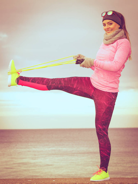 Woman training outdoor with jump rope on cold day - Photo, Image