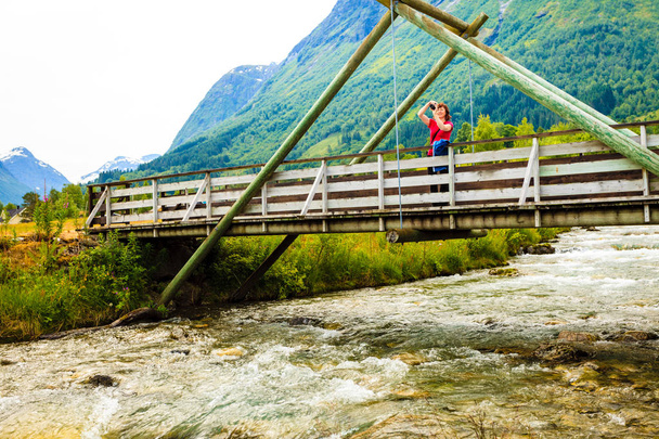 Tourist relaxing on bridge in village Oppstryn Norway - Фото, изображение