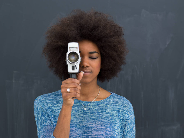 african american woman using a retro video camera - Photo, Image