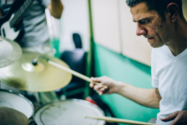 Behind scene. Drummer artist musician playing the drums with dru - Photo, image