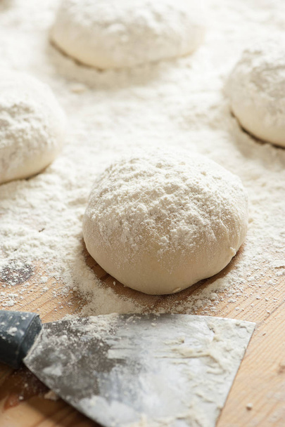 balls of dough covered with wheat flour ready for baking - Valokuva, kuva