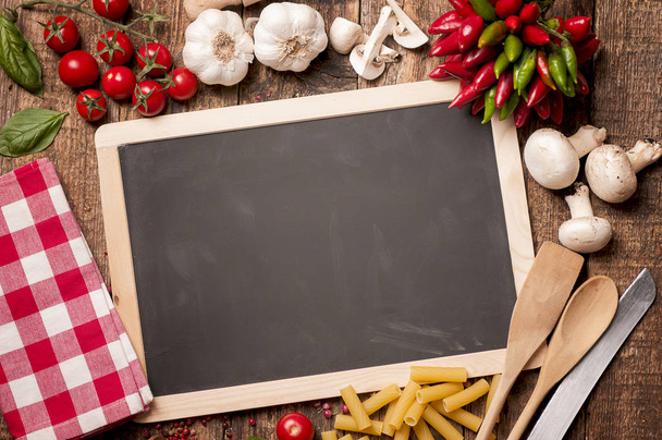 Pasta cooking background with chalkboard, tomatoes, basil and ol - Photo, Image
