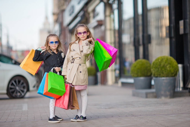 Adorable little girls on shopping in the city outdoors - Photo, Image