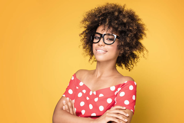 African american girl in eyeglasses on yellow background. - Foto, Imagem