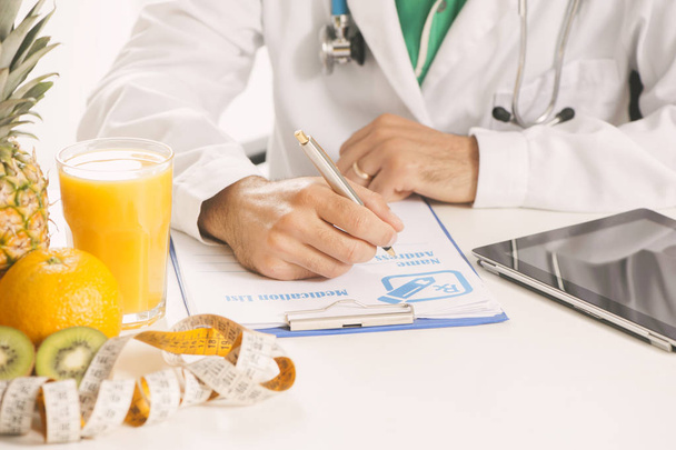 Dietitian doctor writing a diet list - Фото, изображение