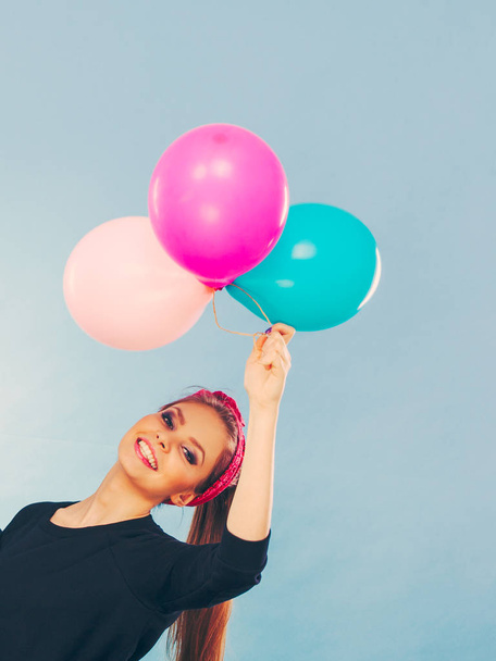 Lovely smiling girl holds colorful balloons. - 写真・画像