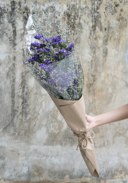 Hands holding bouquet of flower - Φωτογραφία, εικόνα
