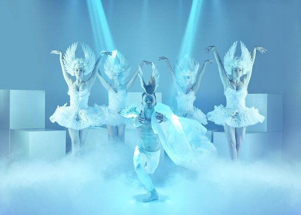 The studio shot of group of modern dancers on blue background - Фото, изображение