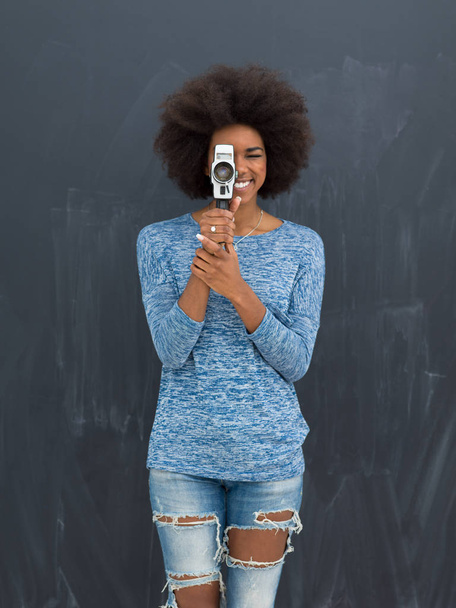 african american woman using a retro video camera - Photo, Image
