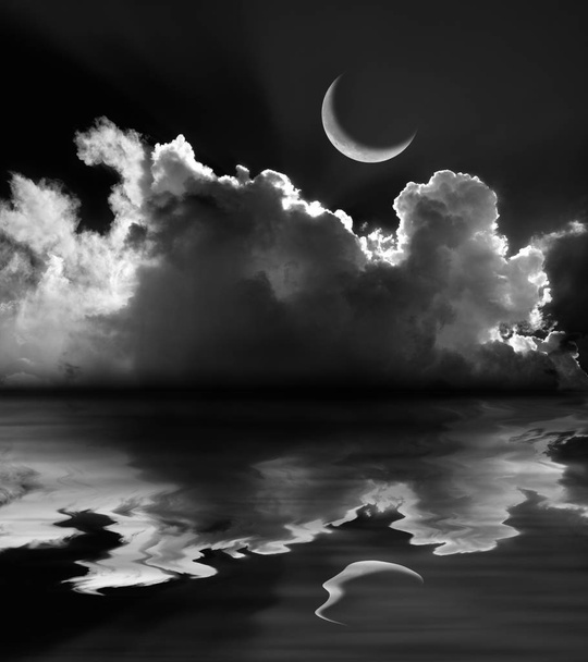 Moonlit fluffy clouds and crescent moon reflection in black and white - Photo, Image