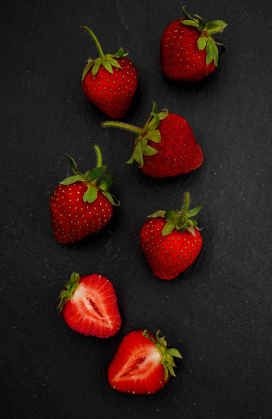 Strawberries on a black stone  - Foto, Bild