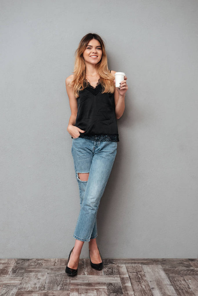 Young lady with cup of coffee posing isolated - Fotoğraf, Görsel