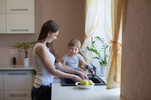 kitchen mom son wash fruits and vegetables - Foto, immagini