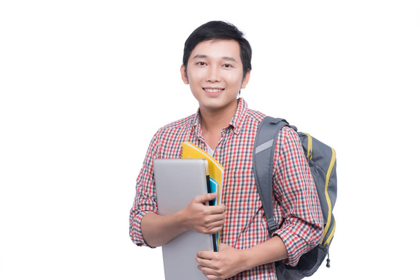  Student hält Bücher und Laptop in der Hand - Foto, Bild