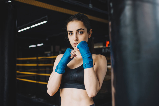 Beautiful and fit female fighter getting prepared for the fight or training - Foto, Imagem