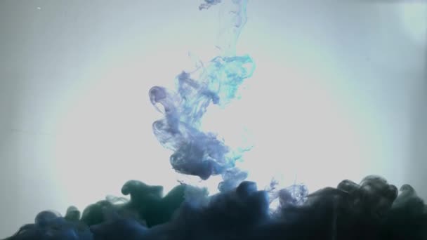 Smoky blue and pink ink in motion on water. Abstract pattern with blue colours ink in water. Blue Smoke goes down - Materiał filmowy, wideo