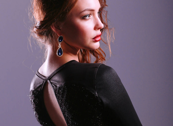 Beautiful woman with evening make-up in black dress - Foto, imagen