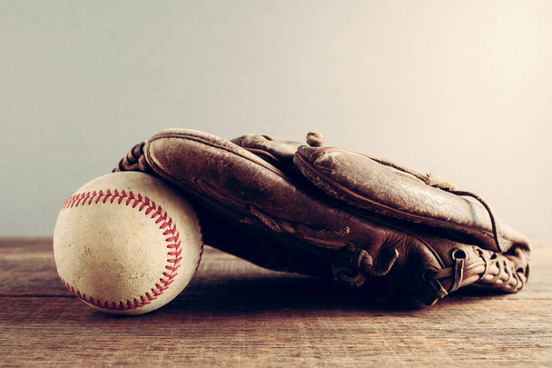 old Baseball and glove on wood background with filter effect retro vintage style - Fotoğraf, Görsel