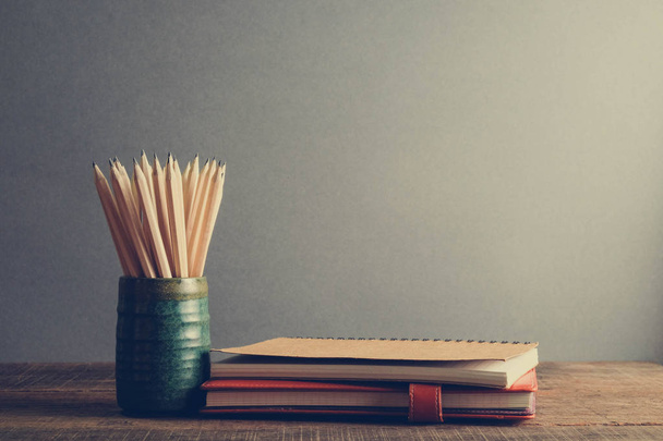 Concept of education pencil and book on table with filter effect retro vintage style - Фото, зображення