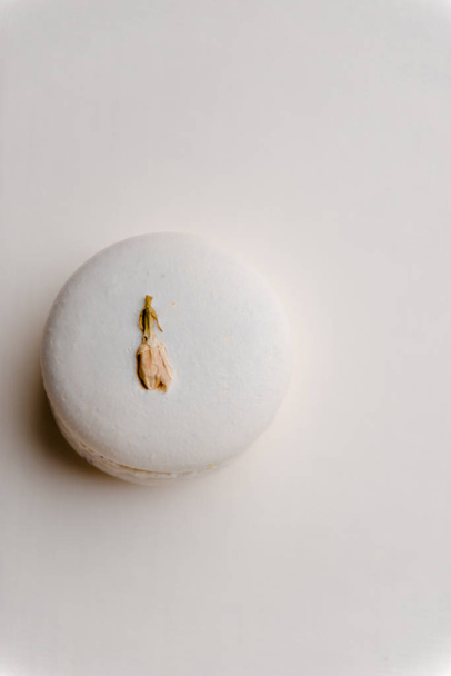 One sweet white macaroon on white table background. - Photo, Image