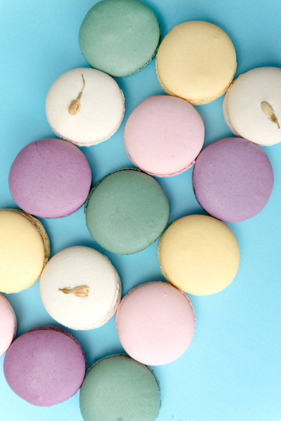 Sweet colorful macaroons on blue table background. - Foto, immagini