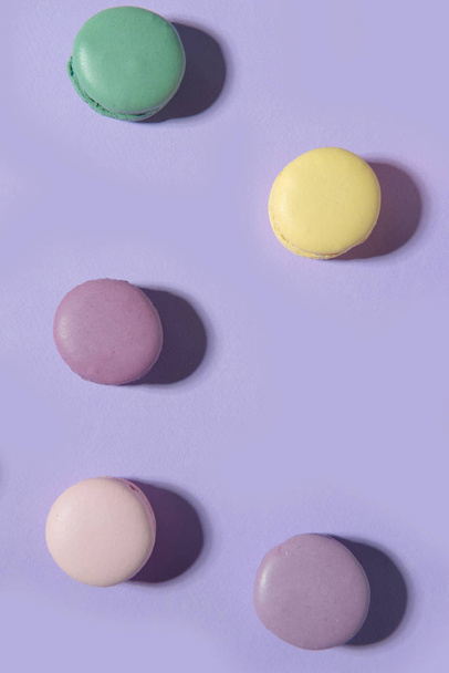 Sweet colorful macaroons on purple table background. - Foto, immagini