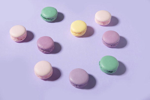 Sweet colorful macaroons on purple table background. - Foto, immagini
